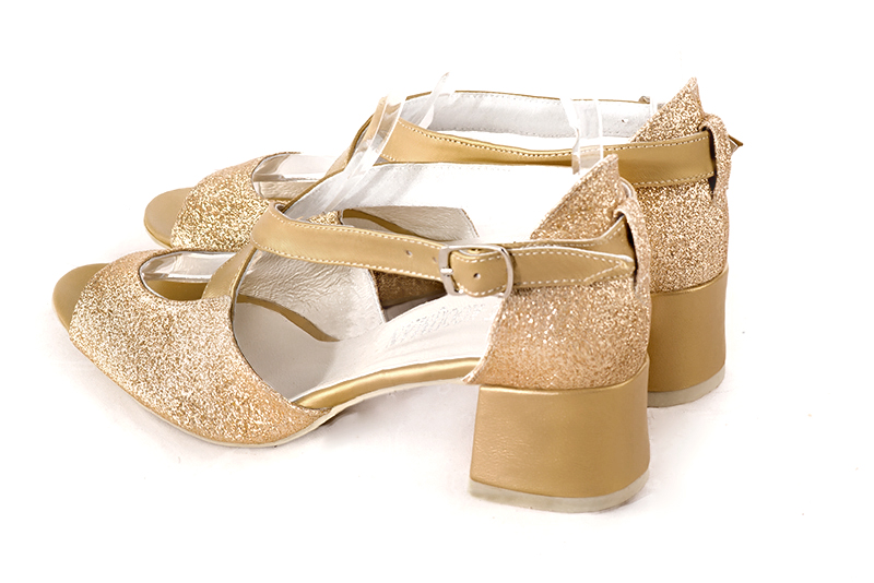 Gold women's closed back sandals, with crossed straps. Round toe. Low flare heels. Rear view - Florence KOOIJMAN